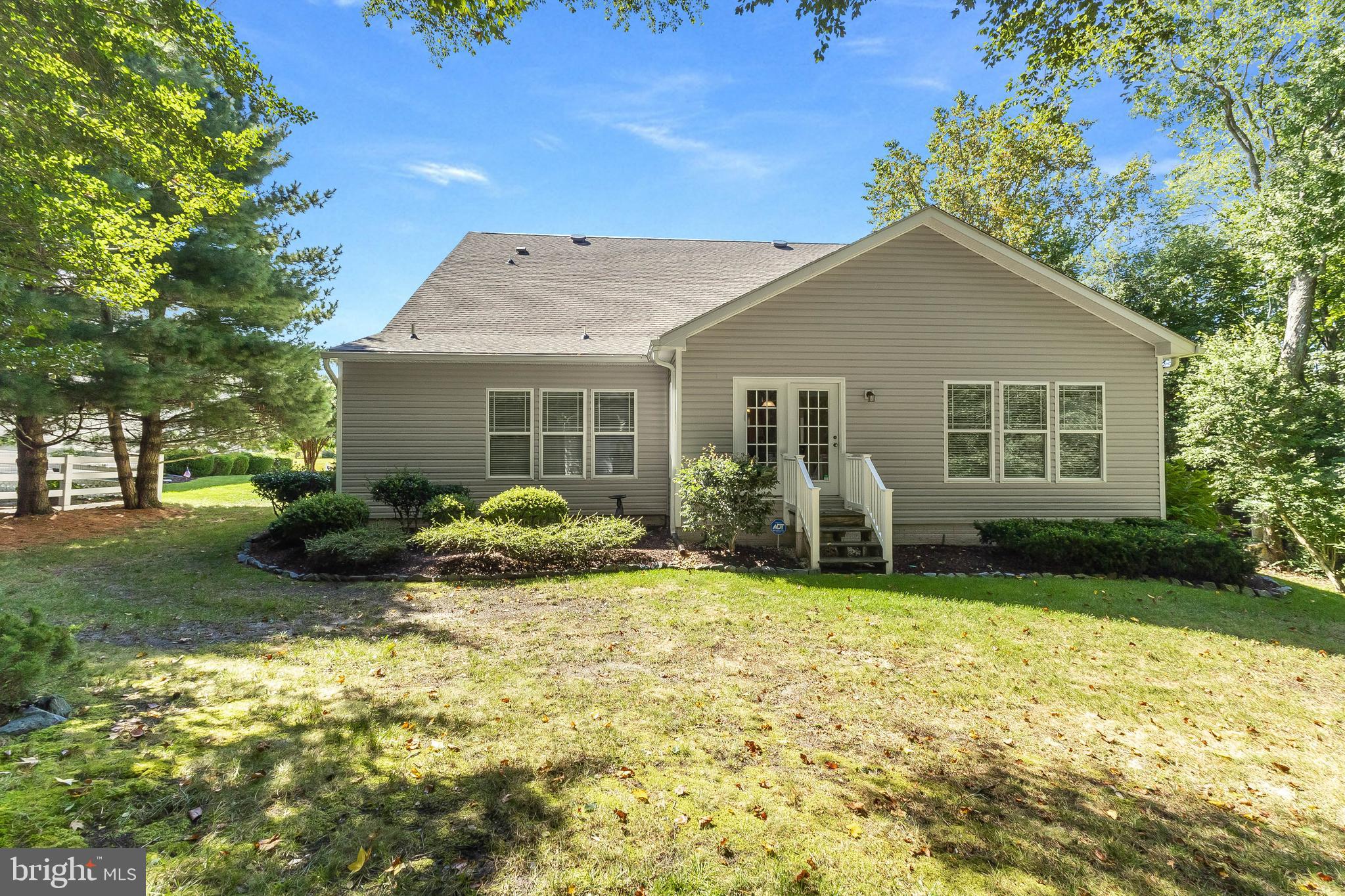 24872 Rivers Edge Road Millsboro, DE 19966 - Photo 58 of 80 a view of a house with backyard sitting area and garden