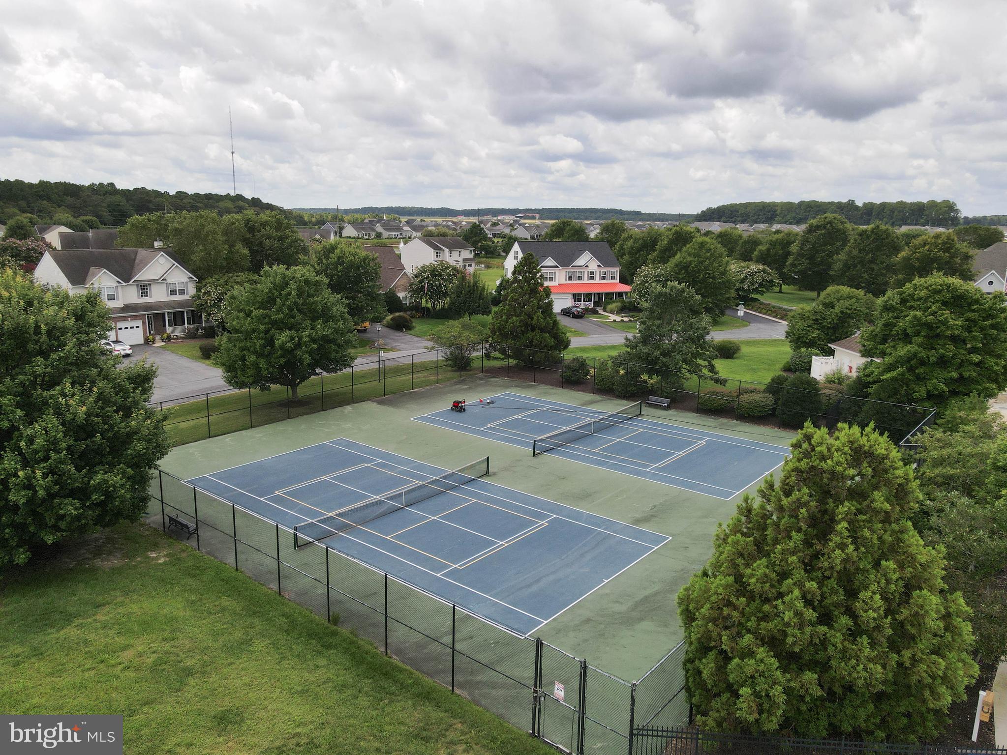 24872 Rivers Edge Road Millsboro, DE 19966 - Photo 72 of 80 an aerial view of a tennis ground and large trees