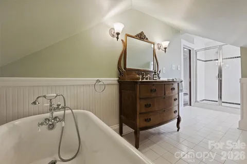 a bathroom with a sink vanity and tub