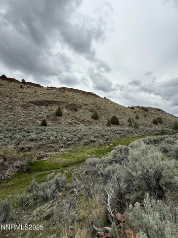 a view of a mountain with mountains in the background
