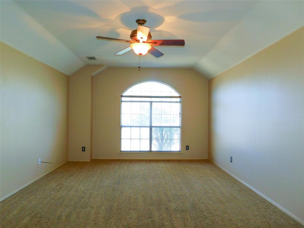2724 Hereford Road Denton, TX 76210 - Photo 23 of 34 an empty room with a chandelier fan and windows