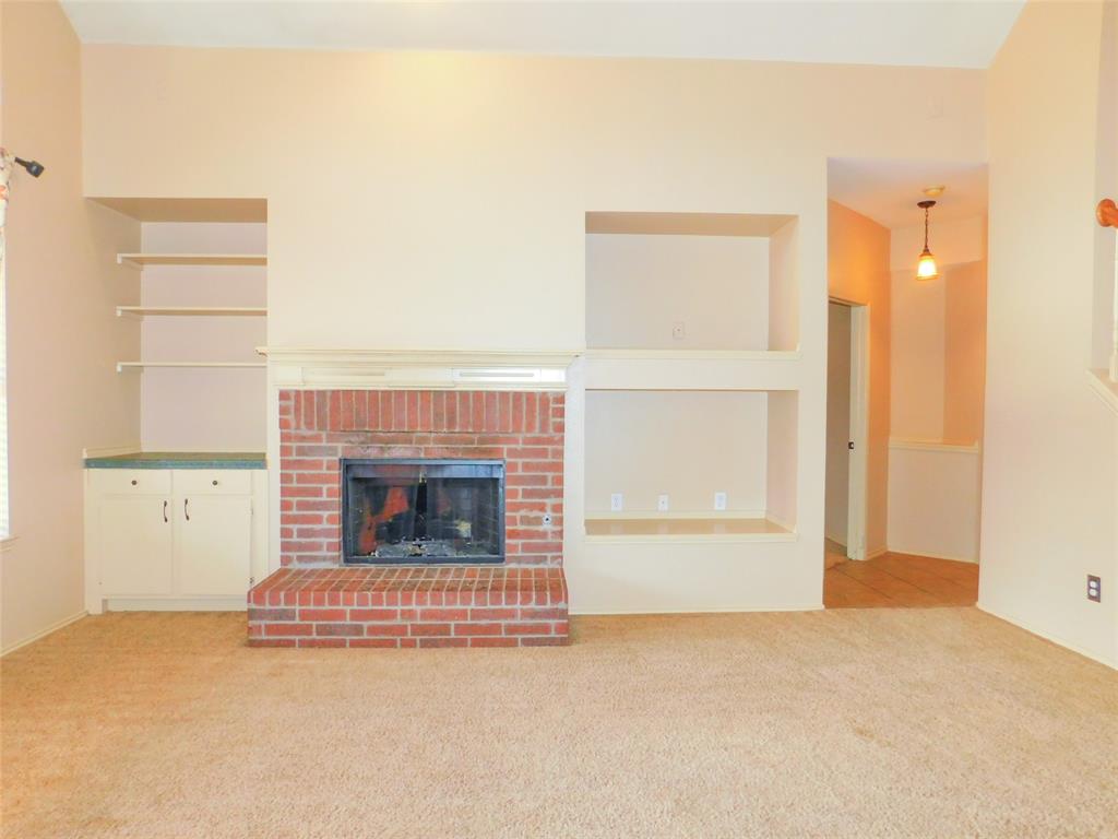 2724 Hereford Road Denton, TX 76210 - Photo 9 of 34 a view of a livingroom with a fireplace and a window