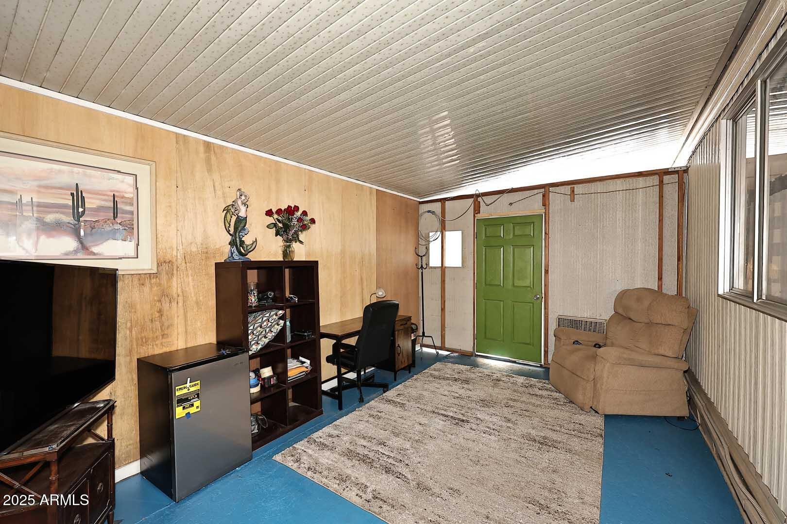 5201 West Camelback Road, Unit 243 Phoenix, AZ 85031 - Photo 13 of 27 a living room with furniture and a flat screen tv
