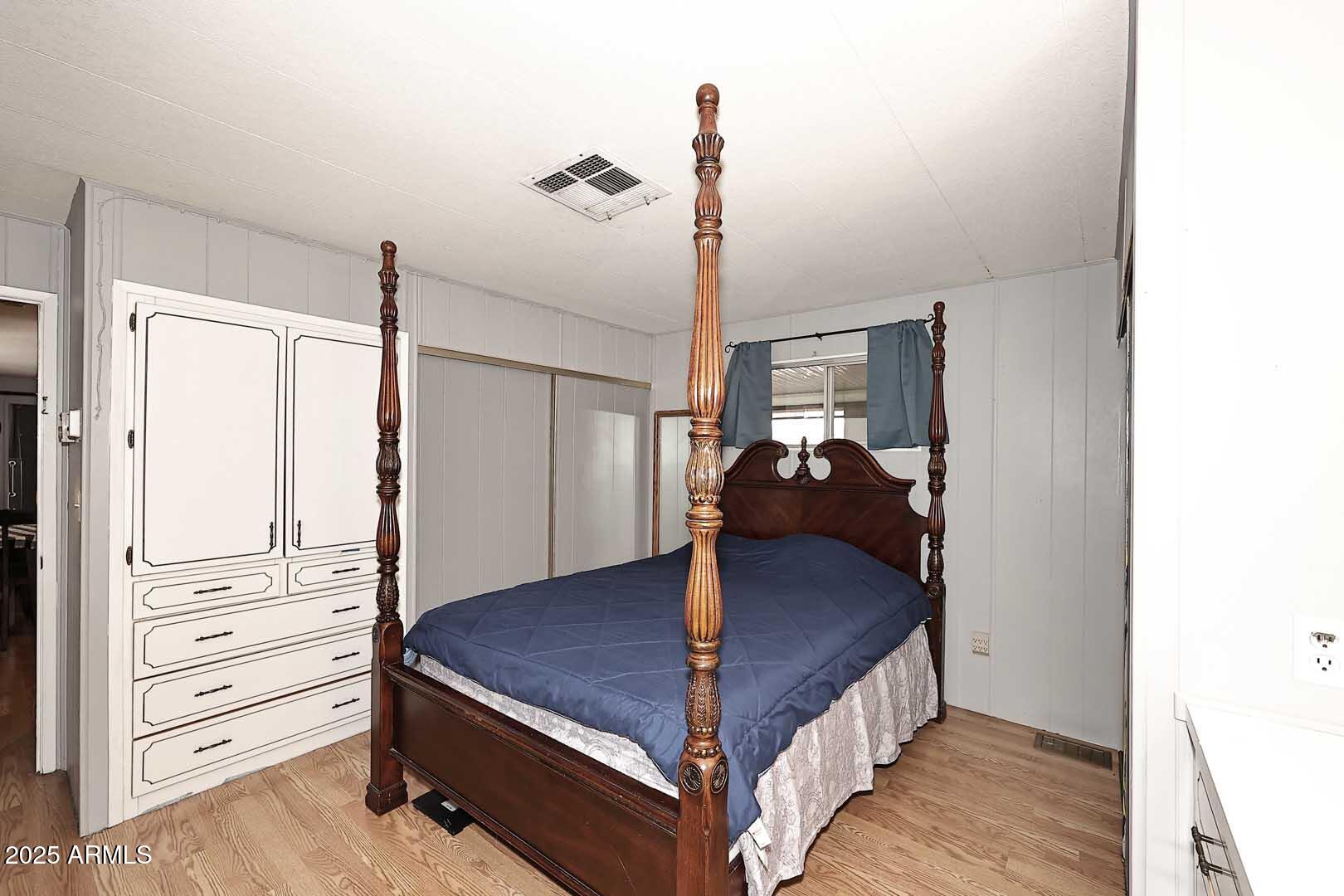 5201 West Camelback Road, Unit 243 Phoenix, AZ 85031 - Photo 15 of 27 a bed room with a bed and dresser