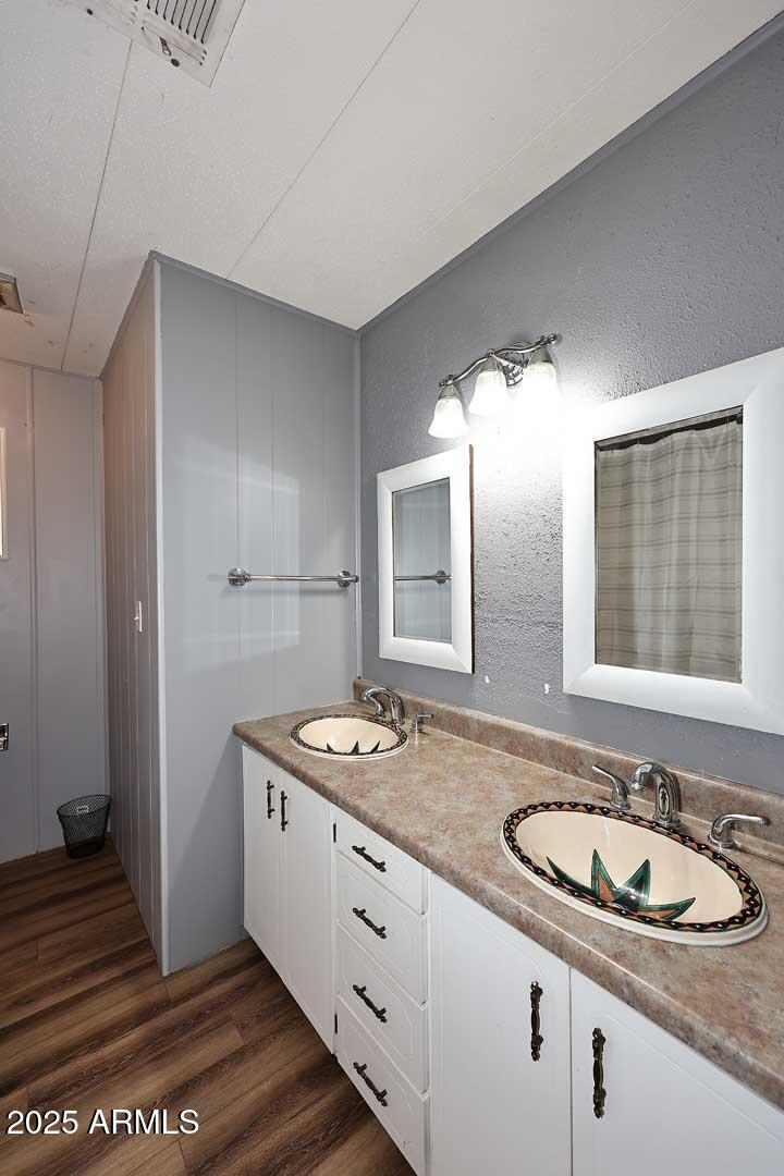 5201 West Camelback Road, Unit 243 Phoenix, AZ 85031 - Photo 17 of 27 a bathroom with a granite countertop sink and a mirror