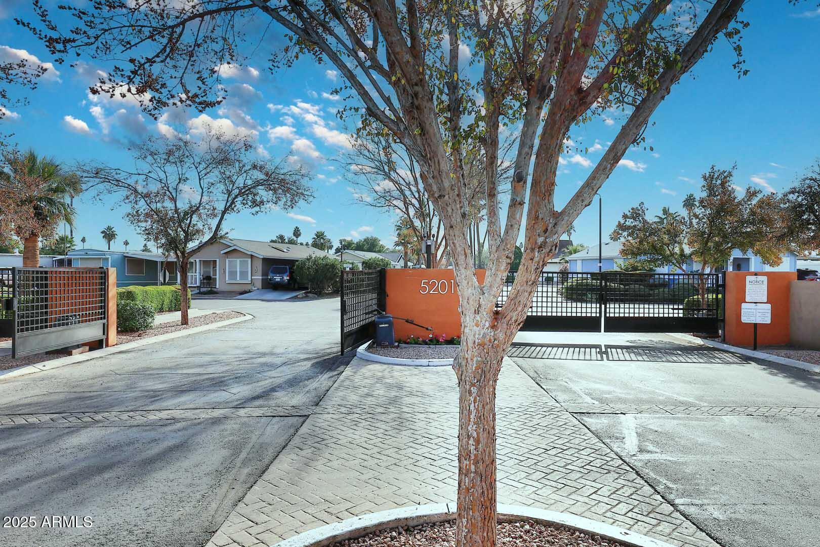 5201 West Camelback Road, Unit 243 Phoenix, AZ 85031 - Photo 2 of 27 a view of a yard with plants and a bench