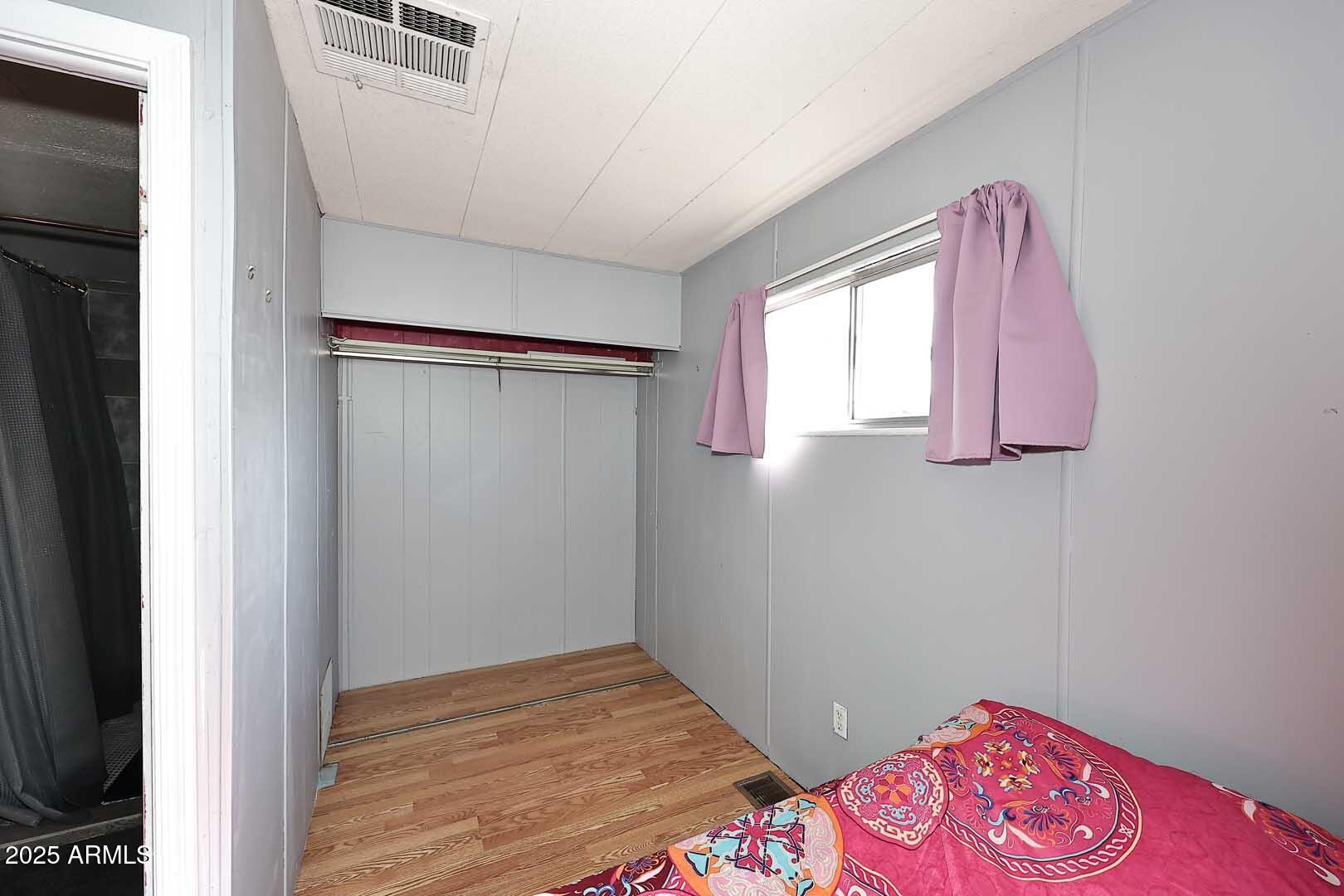 5201 West Camelback Road, Unit 243 Phoenix, AZ 85031 - Photo 22 of 27 a bedroom with a bed and a window