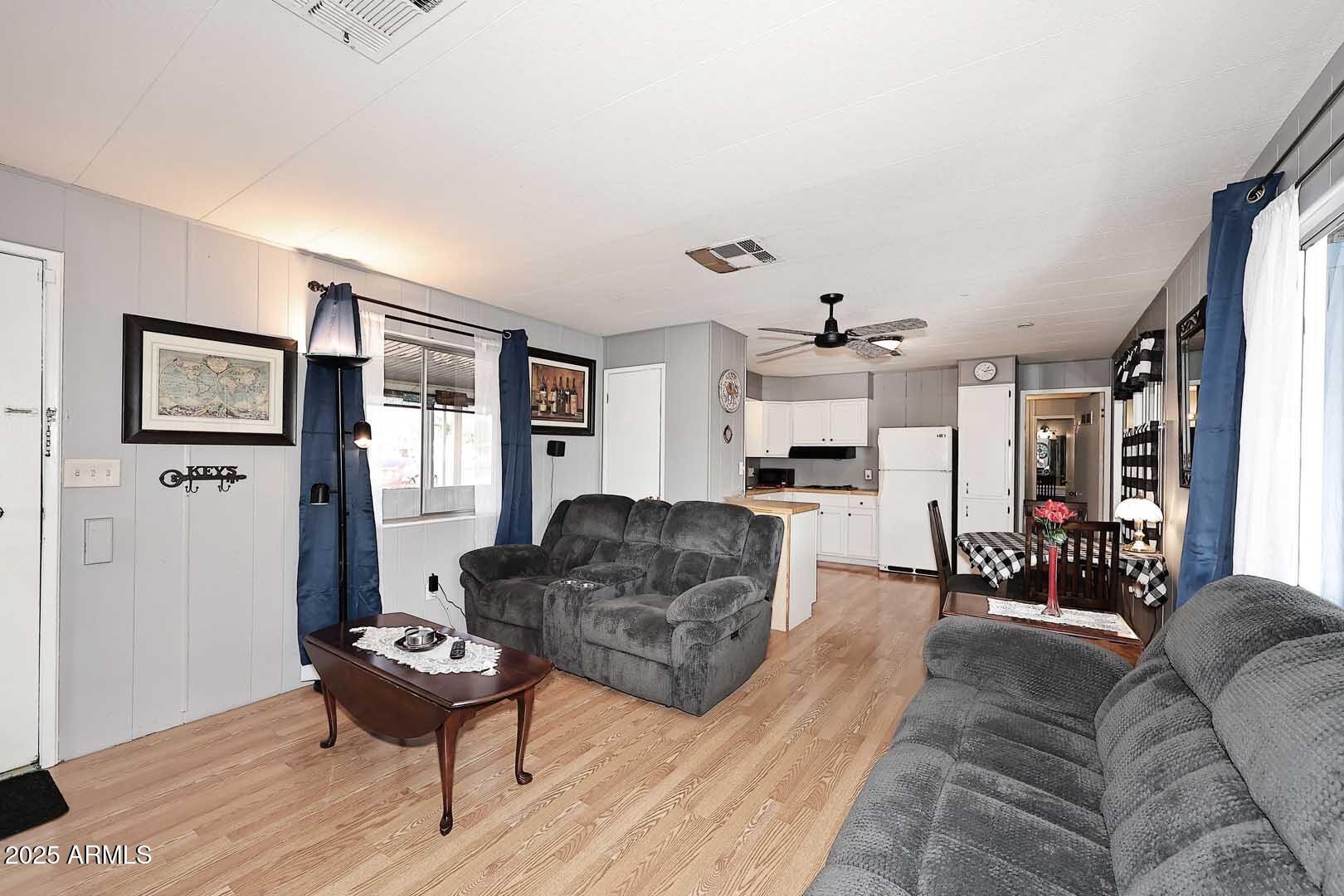 5201 West Camelback Road, Unit 243 Phoenix, AZ 85031 - Photo 9 of 27 a living room with furniture and wooden floor