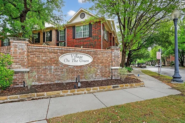 an aerial view of a house with outdoor space and trees all around