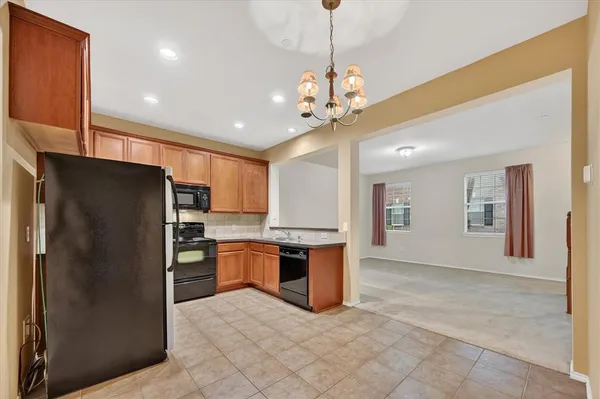 a kitchen with stainless steel appliances granite countertop a refrigerator sink stove microwave and cabinets