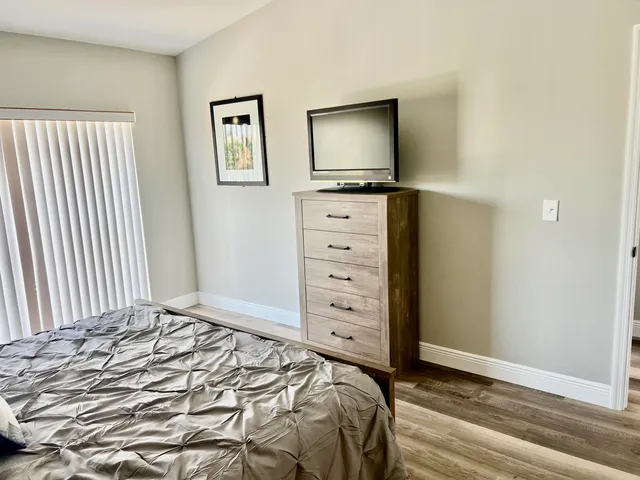 a bed room with two beds and a large window