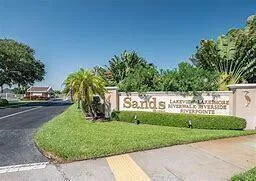a living room with furniture large window and wooden floor