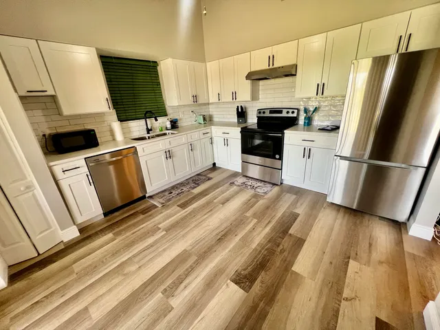 a view of a bedroom with furniture and a window