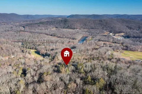 an aerial view of a house with garden space and street view