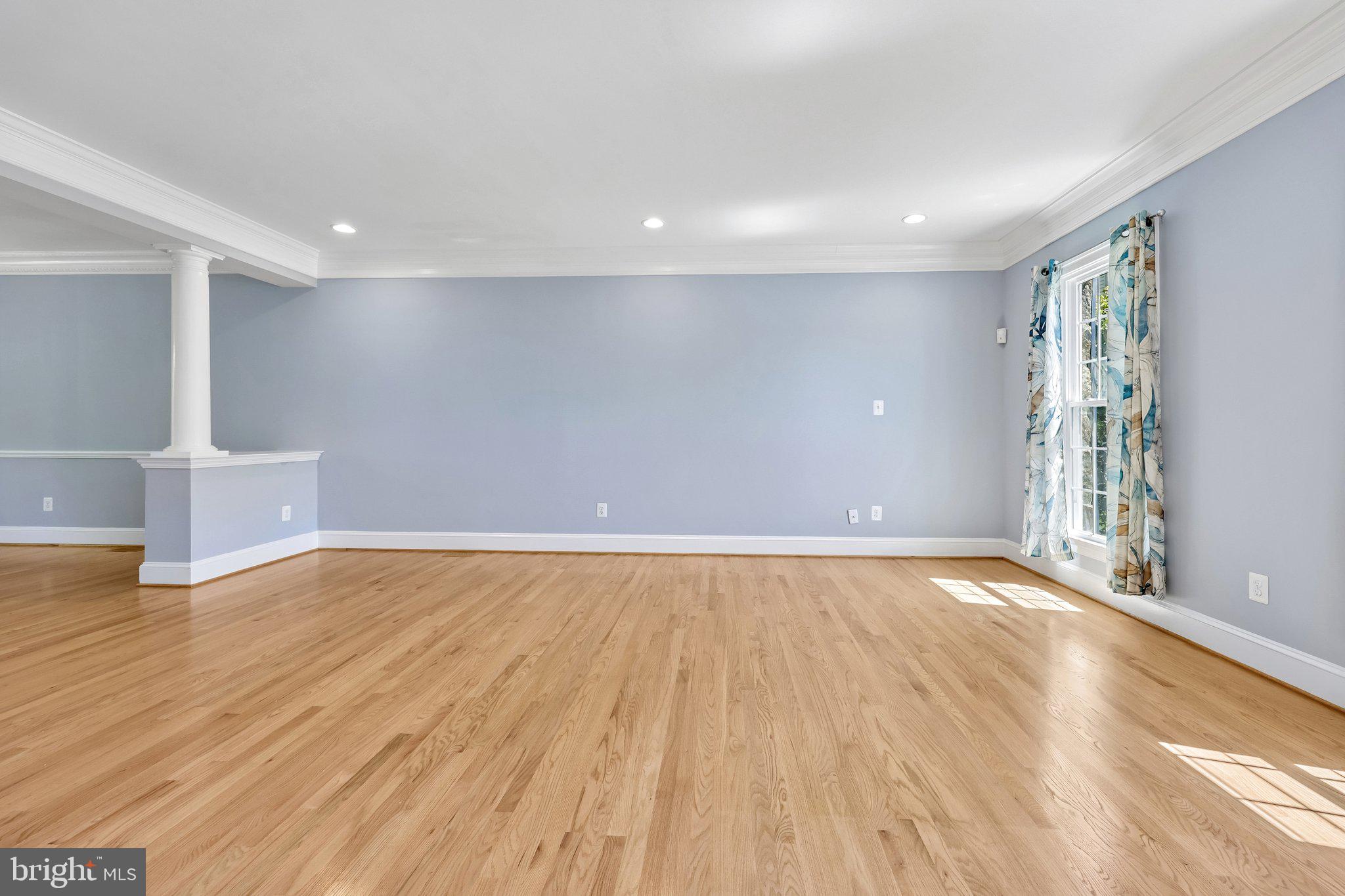 3519 Katrina Court Triangle, VA 22172 - Photo 13 of 101 a view of an empty room with wooden floor and a window