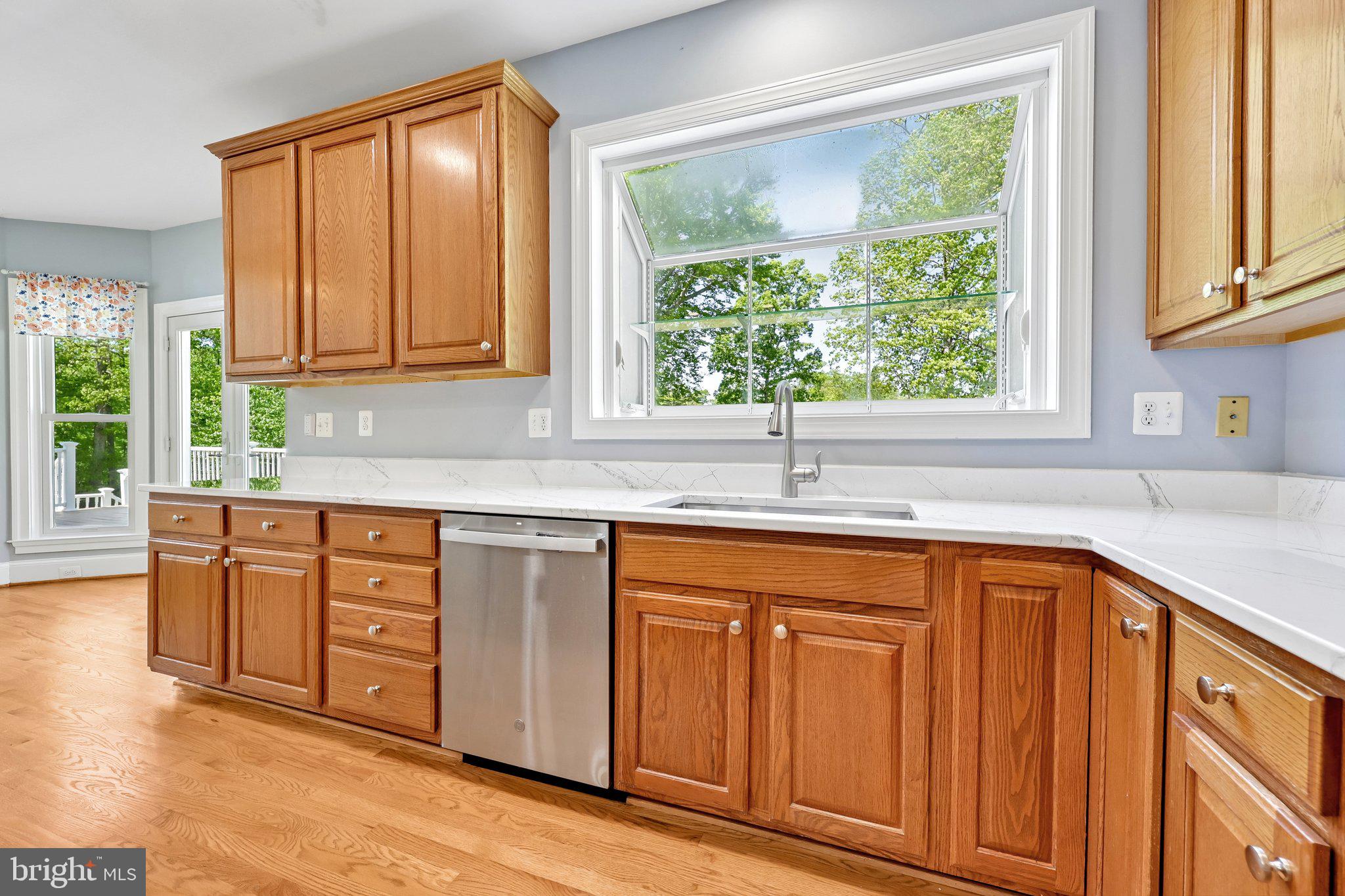 3519 Katrina Court Triangle, VA 22172 - Photo 31 of 101 a kitchen with stainless steel appliances granite countertop wooden cabinets a sink and a large window
