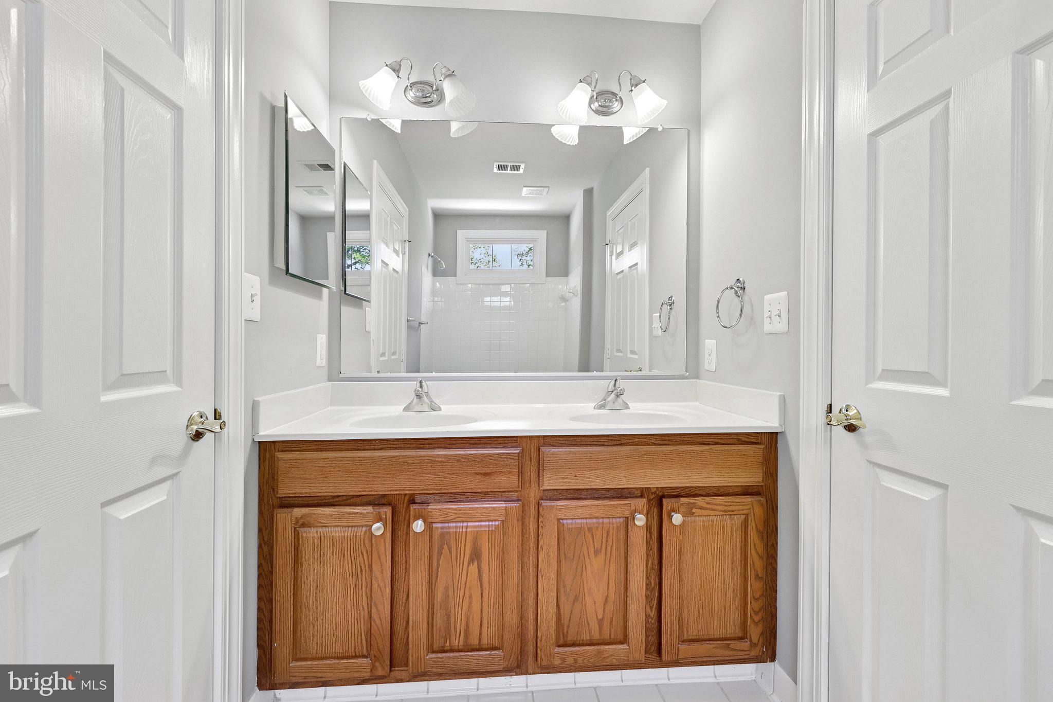 3519 Katrina Court Triangle, VA 22172 - Photo 52 of 101 a bathroom with a granite countertop sink a large mirror and a vanity