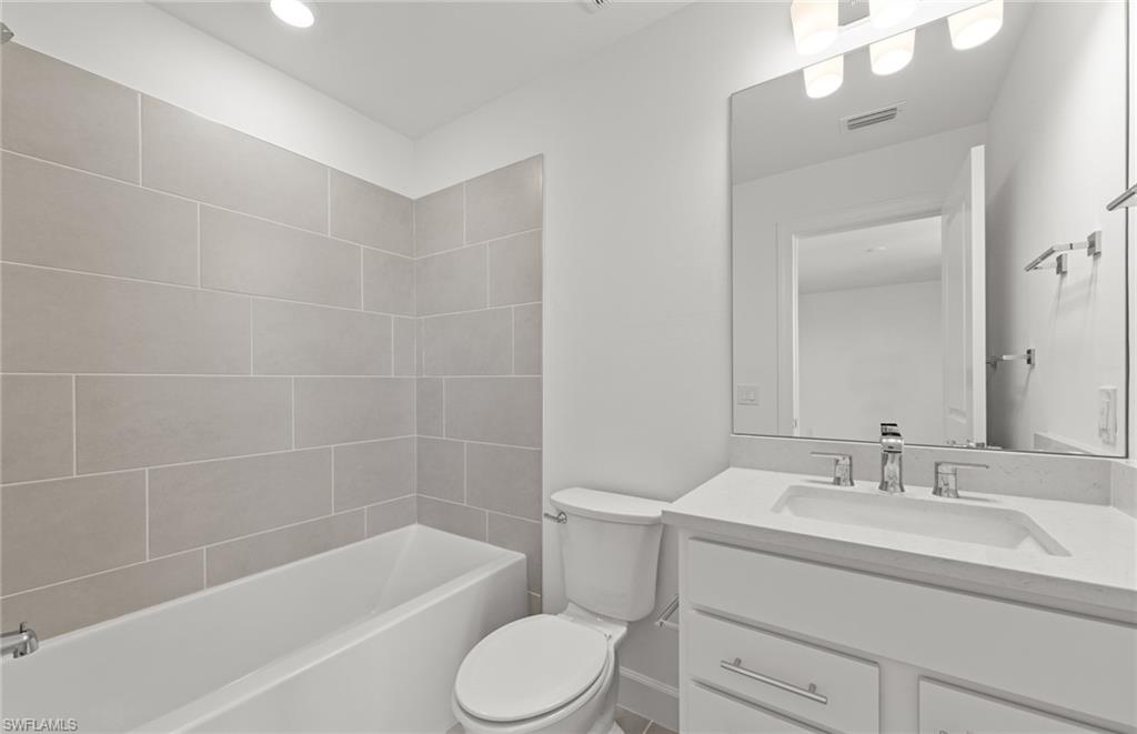 12404 Basalt Lane Alva, FL 33920 - Photo 13 of 50 a bathroom with a bathtub shower sink vanity mirror and toilet