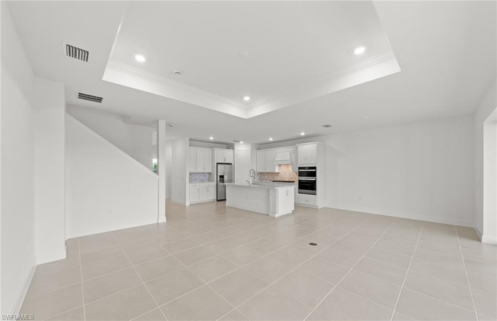 12404 Basalt Lane Alva, FL 33920 - Photo 22 of 50 a view of kitchen with white cabinets and wooden floor