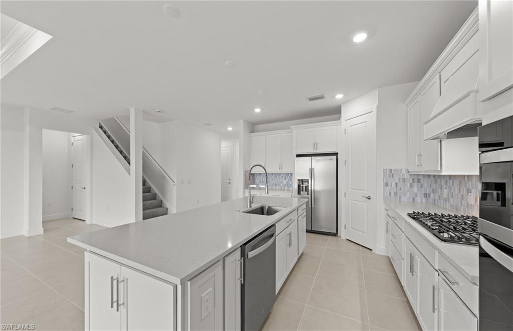 12404 Basalt Lane Alva, FL 33920 - Photo 26 of 50 a kitchen with a sink a counter top space stainless steel appliances and cabinets