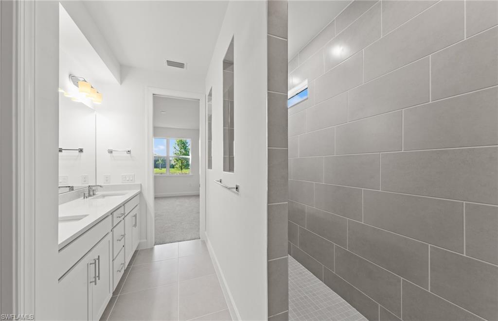 12404 Basalt Lane Alva, FL 33920 - Photo 31 of 50 a bathroom with a double vanity sink and a mirror