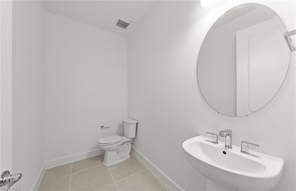 12404 Basalt Lane Alva, FL 33920 - Photo 34 of 50 a bathroom with a toilet a sink and a mirror