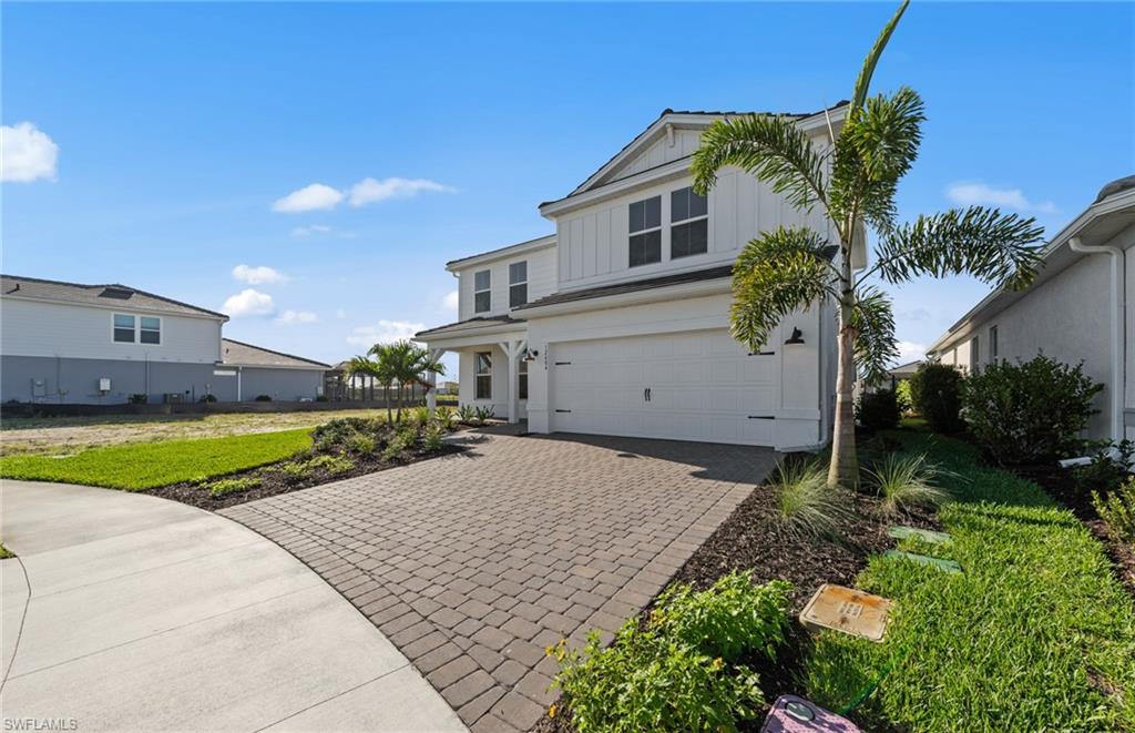 12404 Basalt Lane Alva, FL 33920 - Photo 5 of 50 a front view of a house with a yard and garage