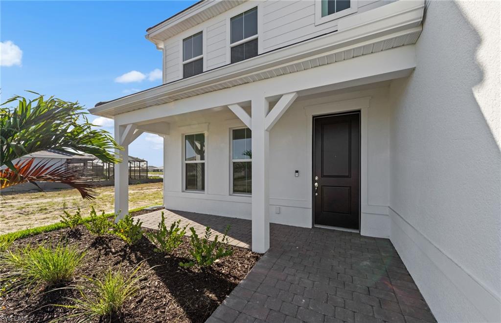 12404 Basalt Lane Alva, FL 33920 - Photo 6 of 50 a front view of a house with garden