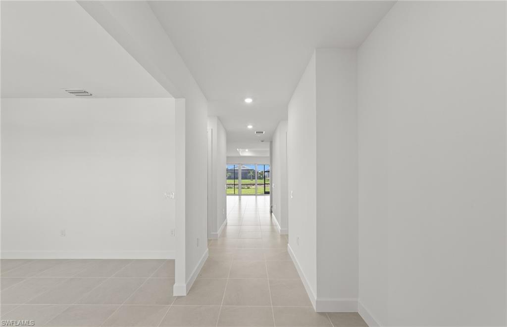 12404 Basalt Lane Alva, FL 33920 - Photo 7 of 50 a view of a hallway with wooden floor