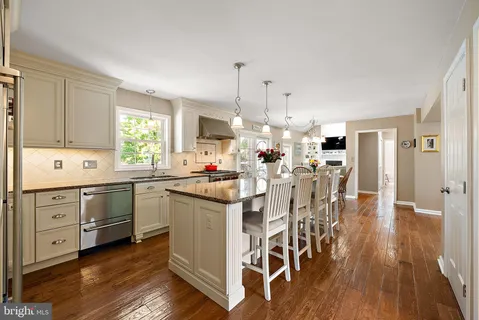 a kitchen with stainless steel appliances granite countertop a stove and cabinets