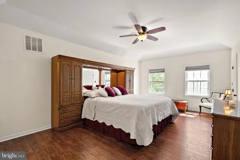 a bedroom with a bed and a fireplace
