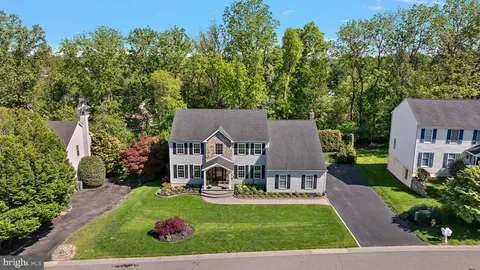 an aerial view of a house with swimming pool garden view and trees