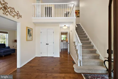 a kitchen that has a lot of cabinets in it and wooden floors