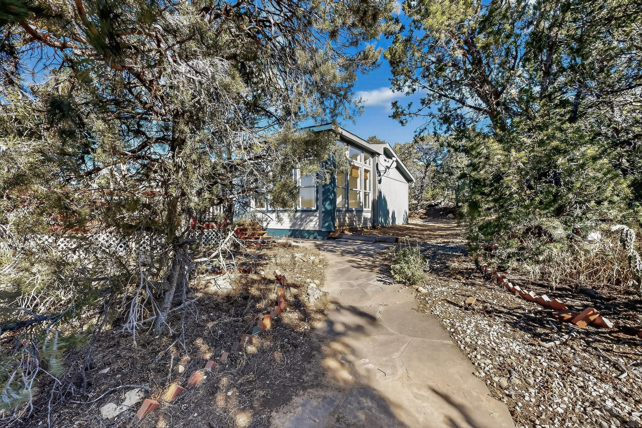 103 Hidden Valley Ranch Road Ilfeld, NM 87538 - Photo 43 of 49 Walkway from patio to home