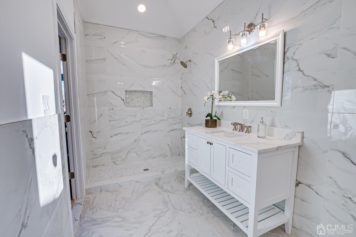 12 Utica Road Edison, NJ 08820 - Photo 34 of 52 a bathroom with a double vanity sink mirror and shower