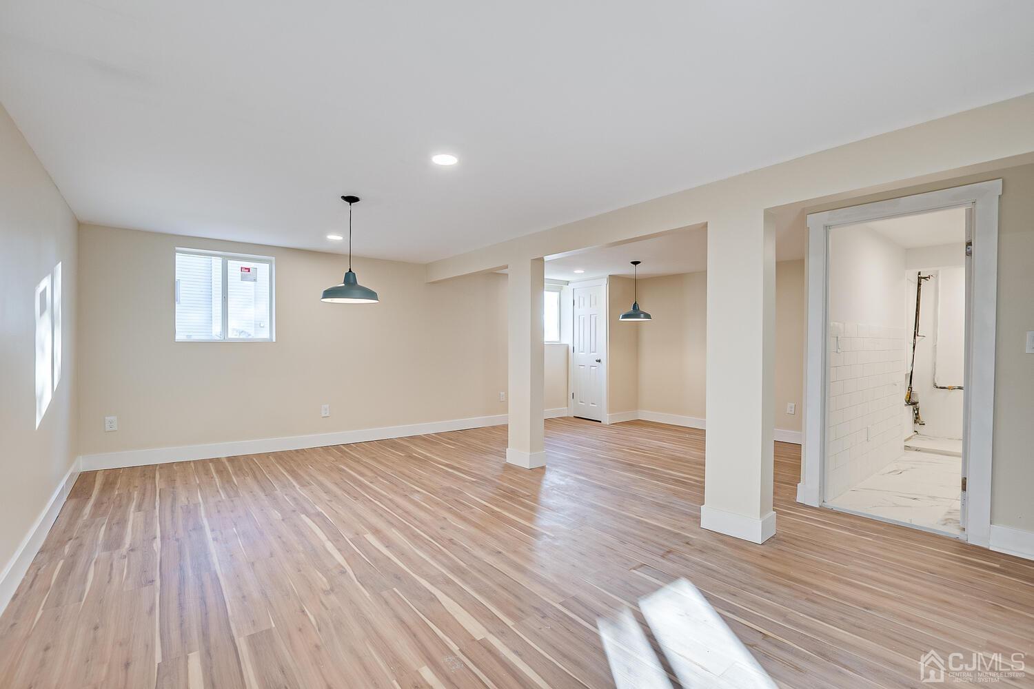 12 Utica Road Edison, NJ 08820 - Photo 44 of 52 a view of an empty room with wooden floor and a window