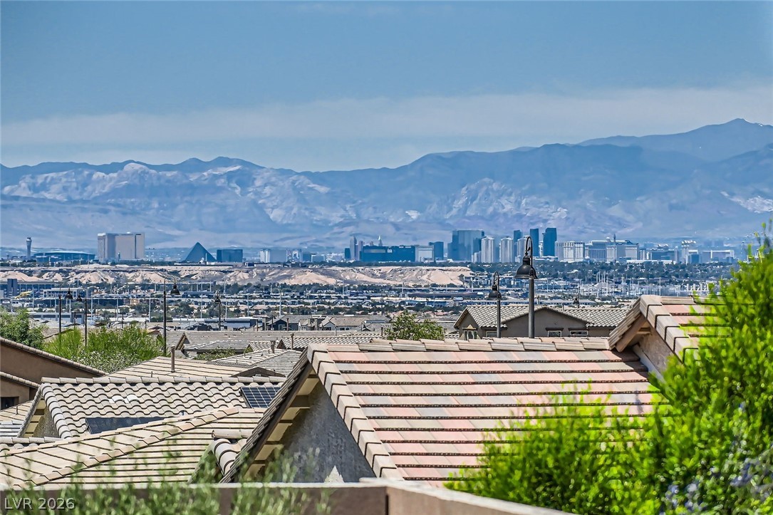 498 Pebble Run Avenue Henderson, NV 89011 - Photo 27 of 47 This panoramic view captures a dynamic cityscape nestled against a backdrop of distant, rugged mountains.