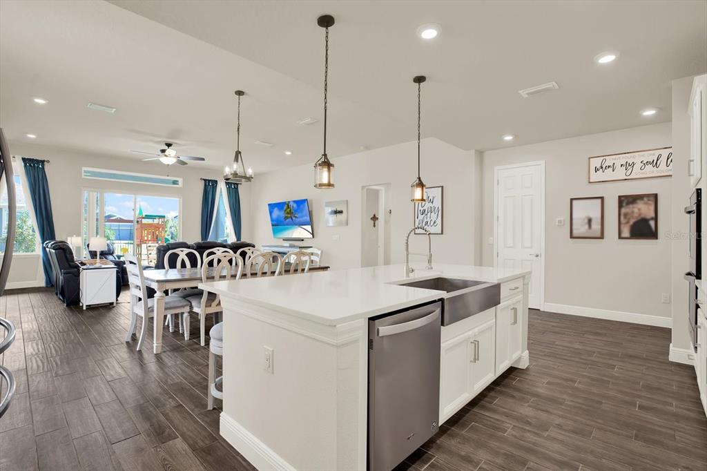 6003 Milestone Drive Apollo Beach, FL 33572 - Photo 12 of 50 a view of kitchen and living room with wooden floor