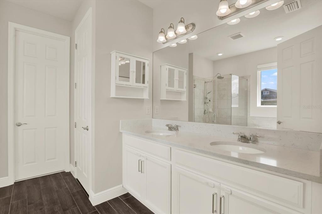 6003 Milestone Drive Apollo Beach, FL 33572 - Photo 19 of 50 a bathroom with a sink vanity granite and a mirror