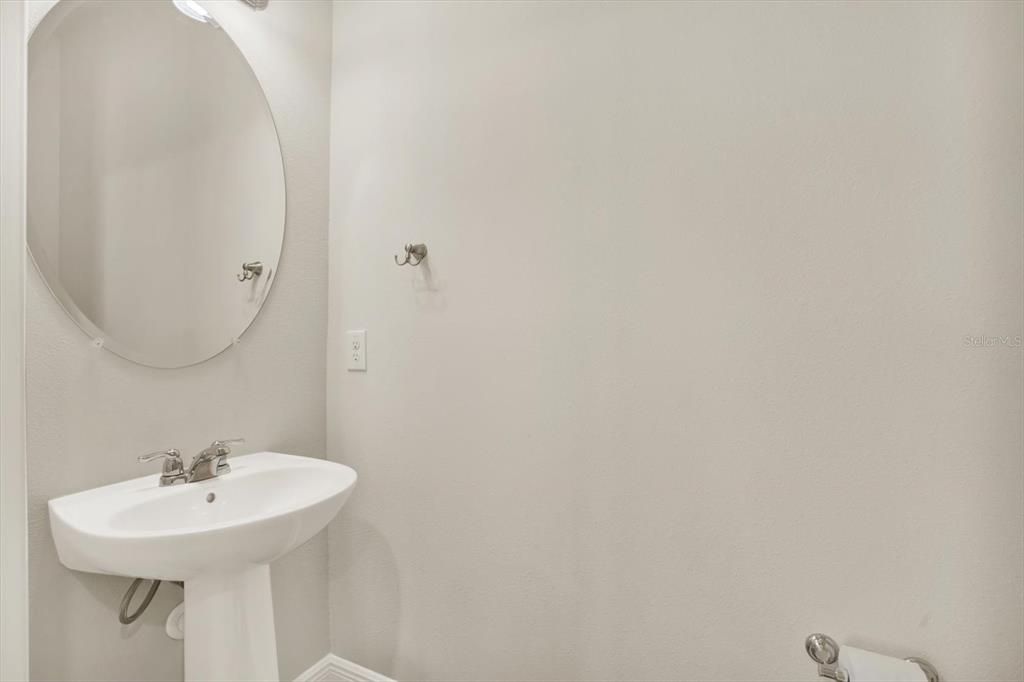 6003 Milestone Drive Apollo Beach, FL 33572 - Photo 25 of 50 a bathroom with a sink a mirror and vanity