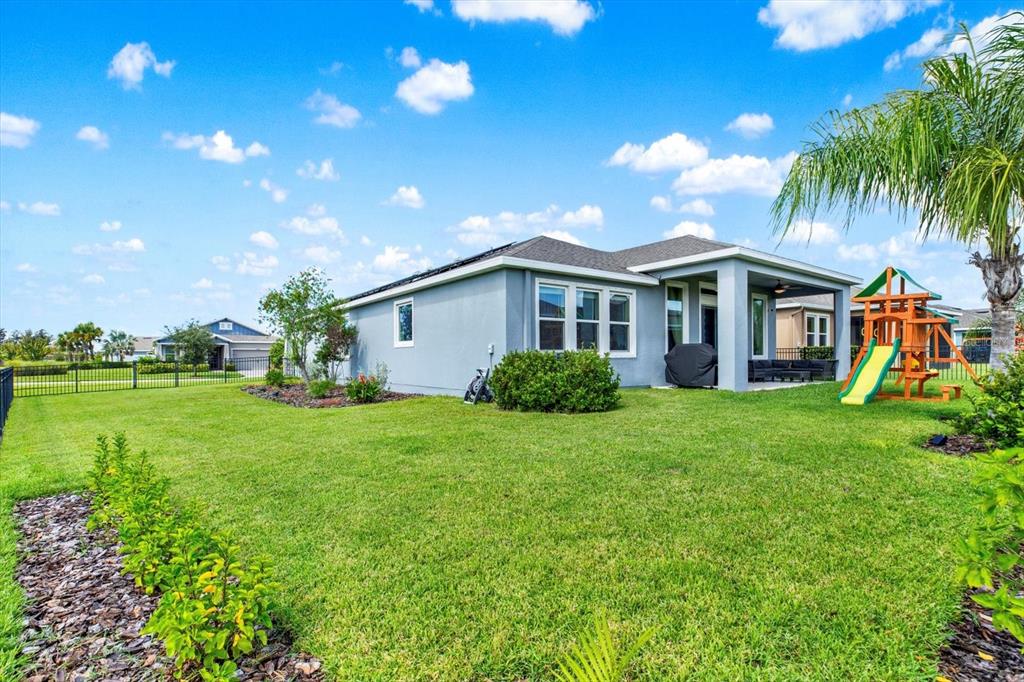6003 Milestone Drive Apollo Beach, FL 33572 - Photo 30 of 50 a view of a house with a backyard and a patio