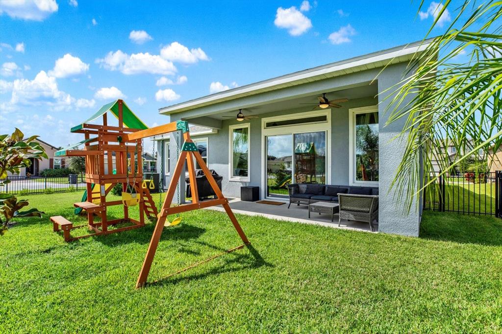 6003 Milestone Drive Apollo Beach, FL 33572 - Photo 3 of 50 a view of a backyard with a slide and a child swing