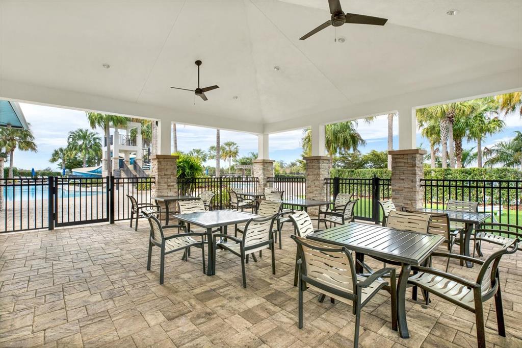 6003 Milestone Drive Apollo Beach, FL 33572 - Photo 42 of 50 a view of a patio with a dining table and chairs
