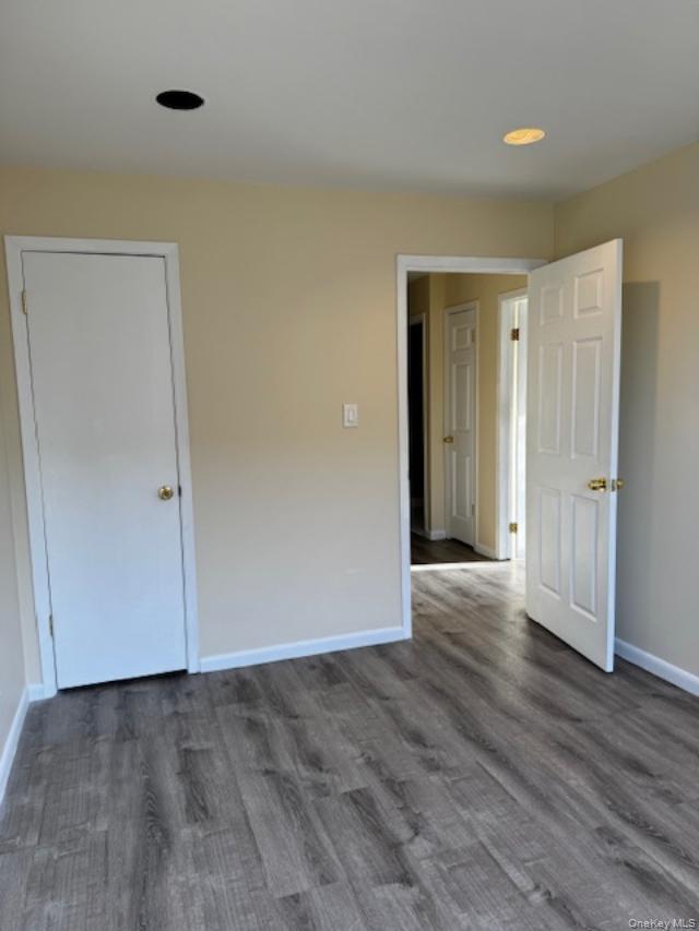 150-40 Tahoe Street, Unit 3C Queens, NY 11417 - Photo 11 of 18 Unfurnished room featuring dark wood-style flooring and baseboards