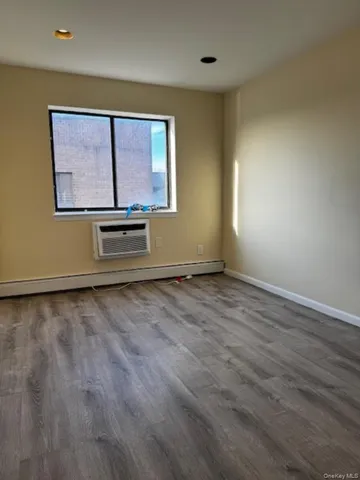 a view of room with window and hardwood floor