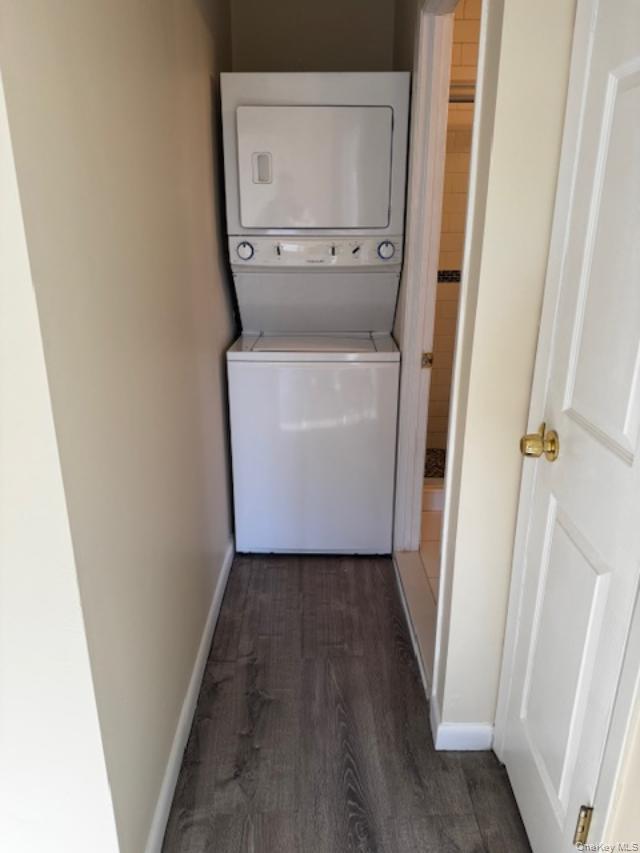 150-40 Tahoe Street, Unit 3C Queens, NY 11417 - Photo 16 of 18 Laundry area featuring stacked washing machine and dryer and dark wood finished floors