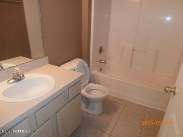 7920 Merrill Road, Unit 310 Jacksonville, FL 32277 - Photo 5 of 7 a bathroom with a sink toilet and shower