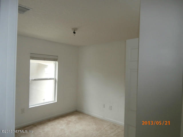 7920 Merrill Road, Unit 310 Jacksonville, FL 32277 - Photo 6 of 7 an empty room with windows