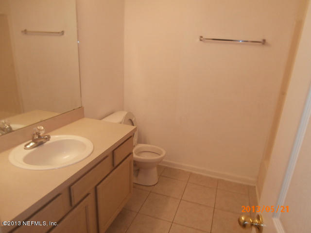 7920 Merrill Road, Unit 310 Jacksonville, FL 32277 - Photo 7 of 7 a bathroom with a sink a toilet and mirror