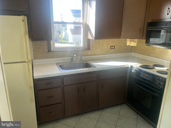 a kitchen with a sink stove and refrigerator